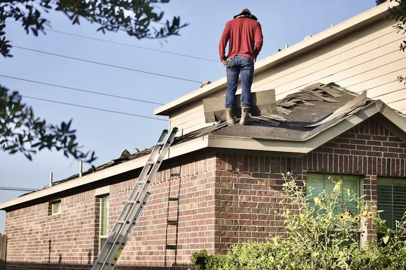 Professional roofer working on a residential roof in Rosedale Park